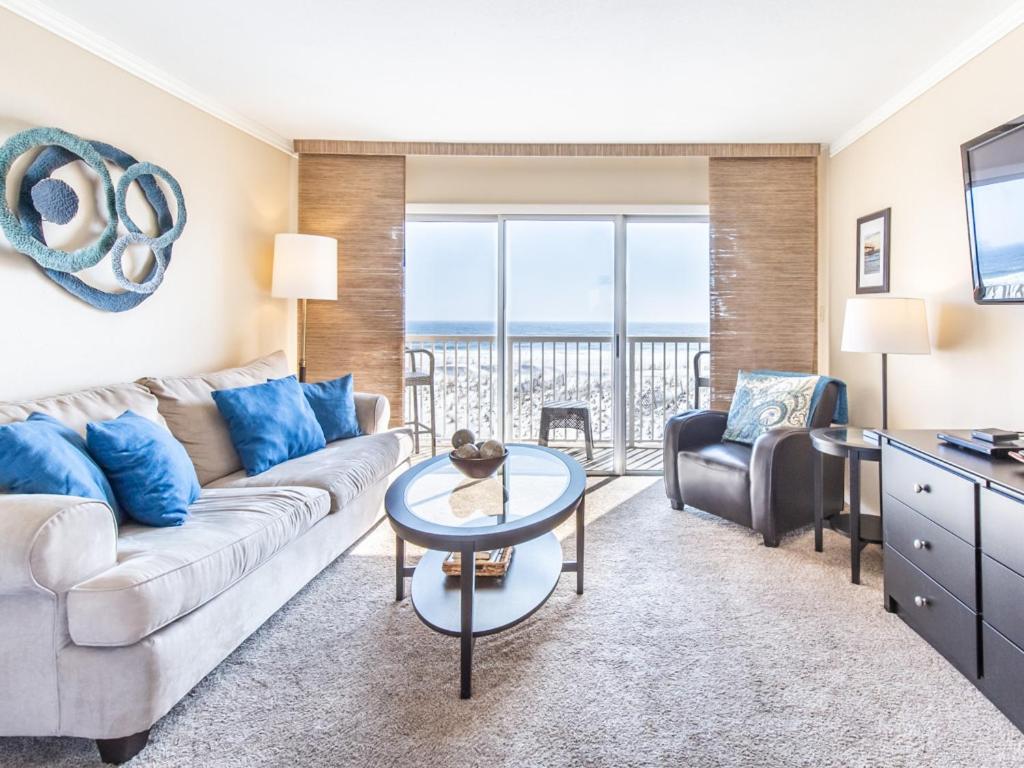 a living room with a couch and a table at Islander Condominiums I in Fort Walton Beach