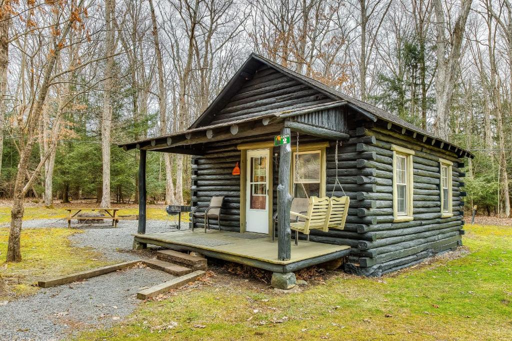 a small log cabin with a porch and a deck at Swallow Falls Cabin #2 in Oakland