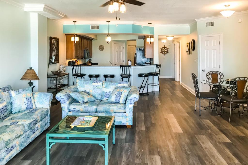 a living room with couches and a kitchen at Paradise Shores 305 in Mexico Beach