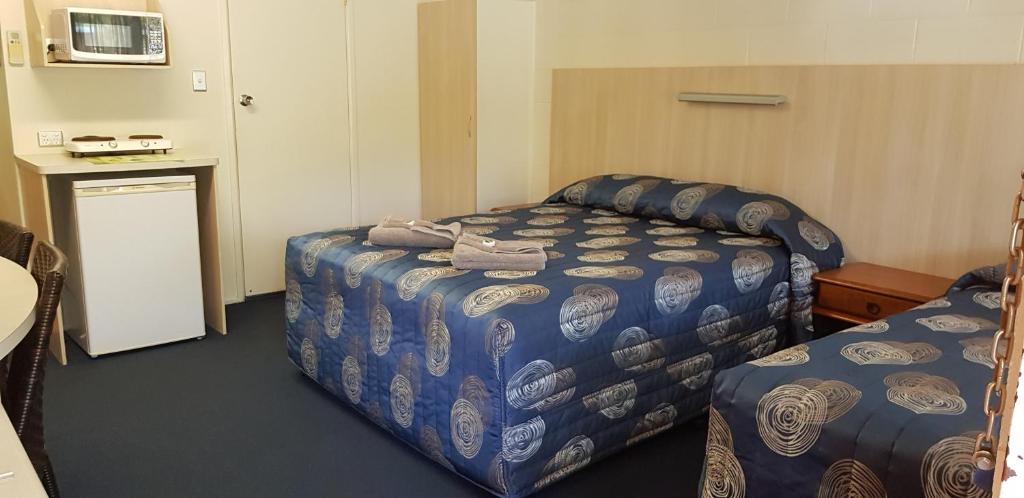 Postel nebo postele na pokoji v ubytování Mango Tree Motel