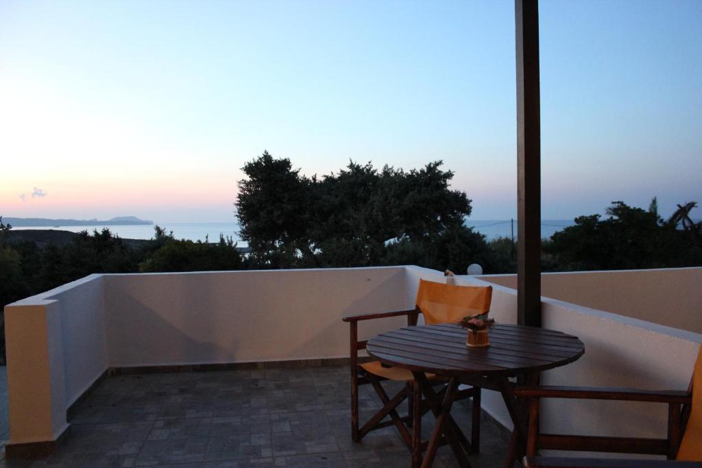 a table and chairs on a balcony with a view at Galini in Agia Irini Milos