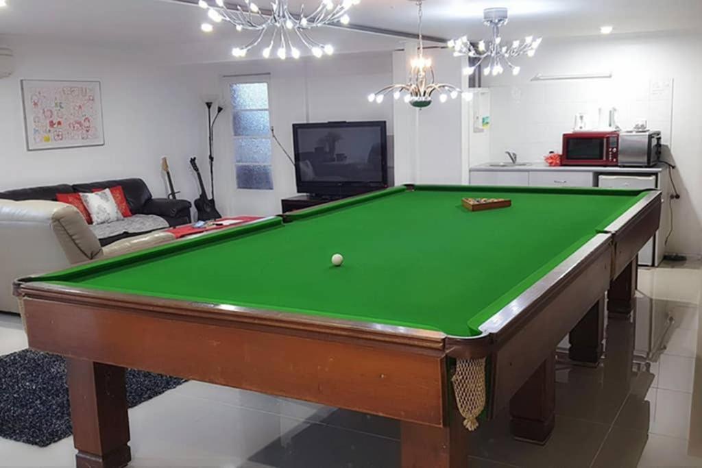 a living room with a pool table at By The Bay in Kingston Beach