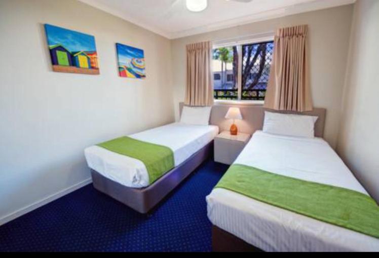a hotel room with two beds and a window at Gold Coast Family Apartment in Gold Coast