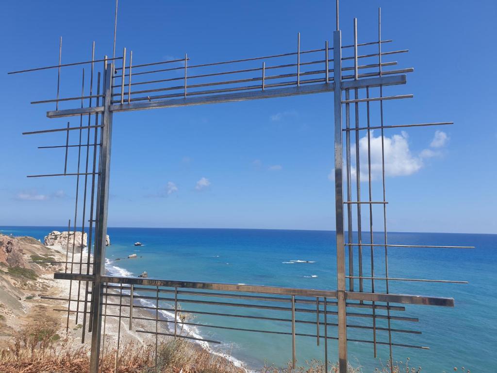 a view of the ocean through a large window at Kings Avenue - Natalia's Apt in Paphos