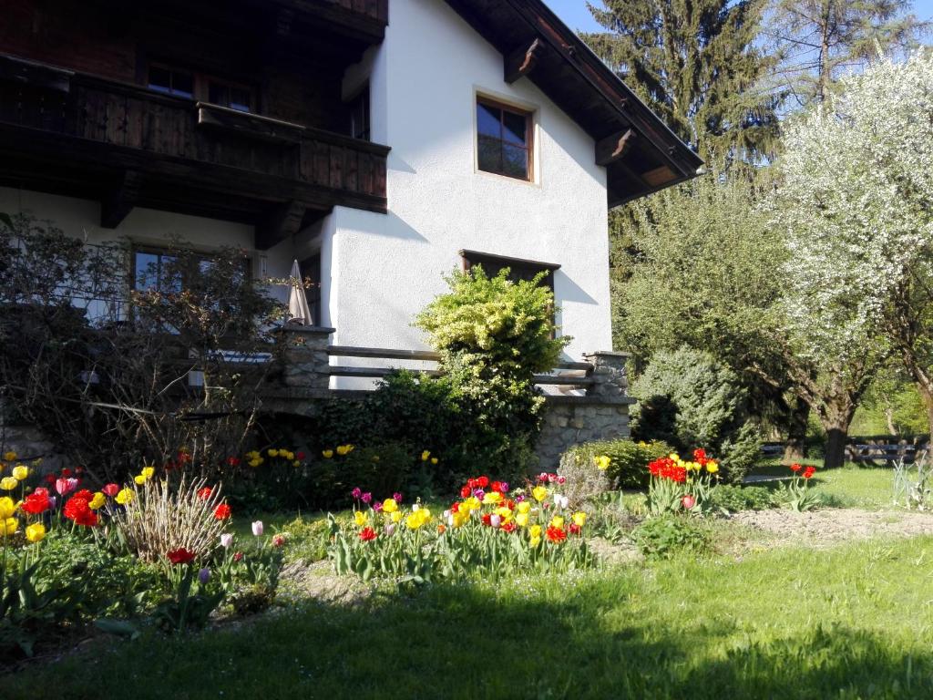 a garden of flowers in front of a house at Apartments EMMA, Zillertal, Tirol in Kaltenbach