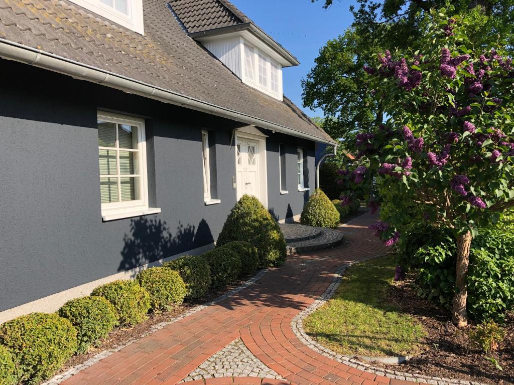 a house with a brick walkway in front of it at Urlaub in Wieck in Wieck