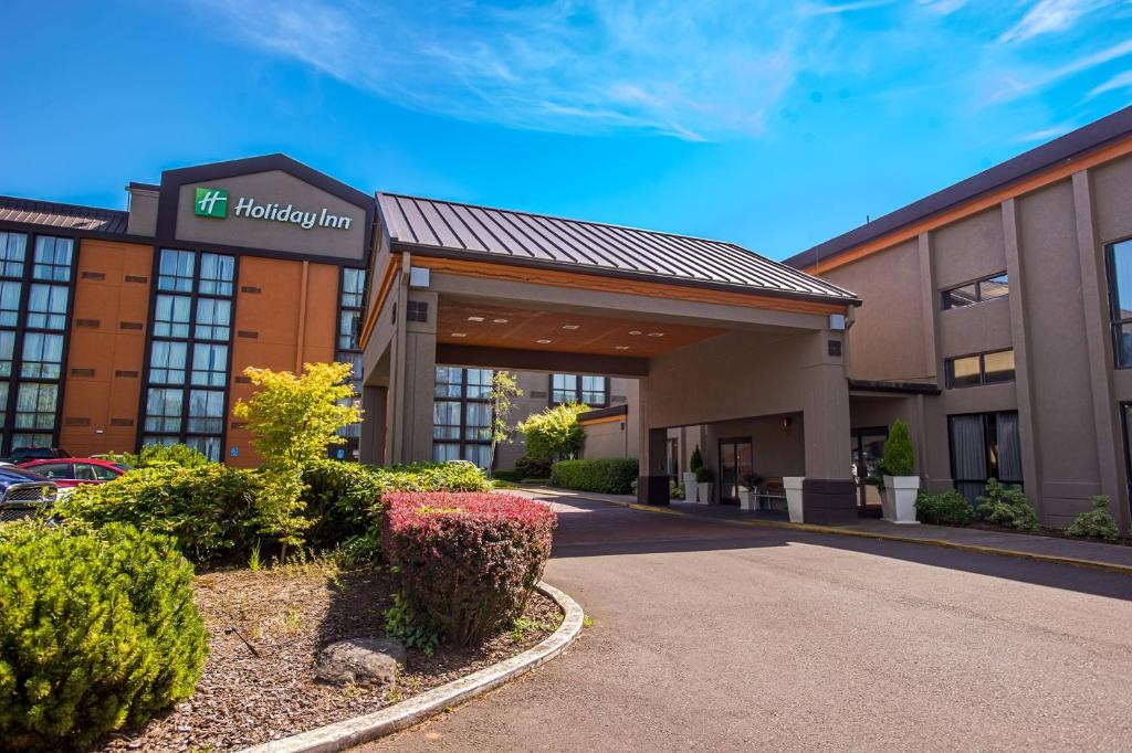 a hotel with a sign on the front of a building at Holiday Inn Portland South/Wilsonville, an IHG Hotel in Wilsonville