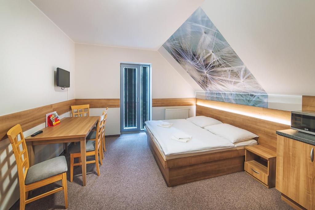 A bed or beds in a room at Apartmány Zaria