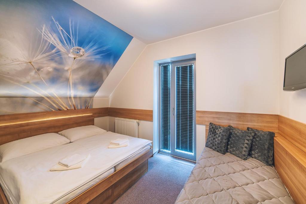 A bed or beds in a room at Apartmány Zaria