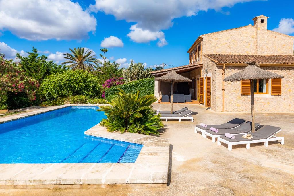 a villa with a swimming pool and a house at Cas Batlet Antonia in S'Horta