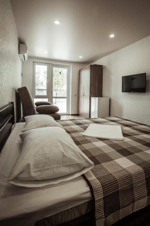 Postel nebo postele na pokoji v ubytování REEF Hotel