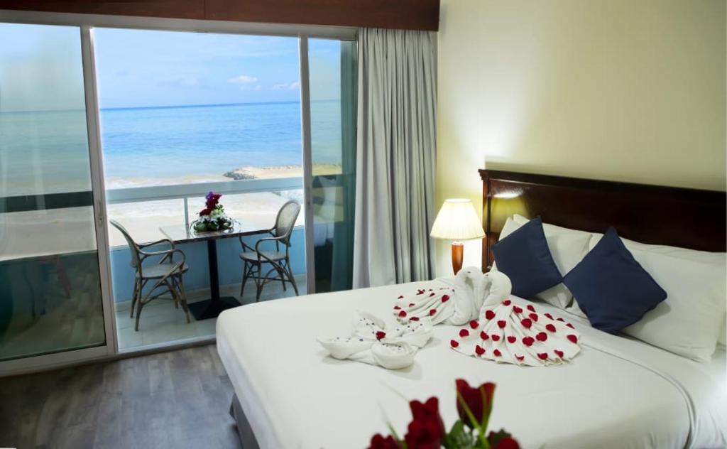 a bedroom with a bed with a view of the ocean at Mermaid Beach Hotel LLC in Ajman 