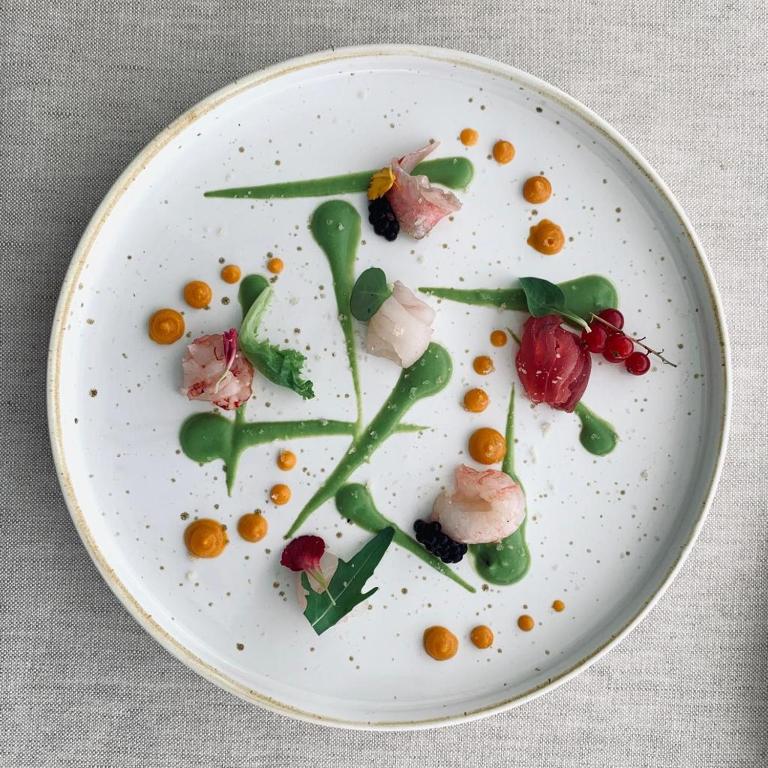 a white plate with some food on it at Elite Boutique Hotel in Roseto degli Abruzzi
