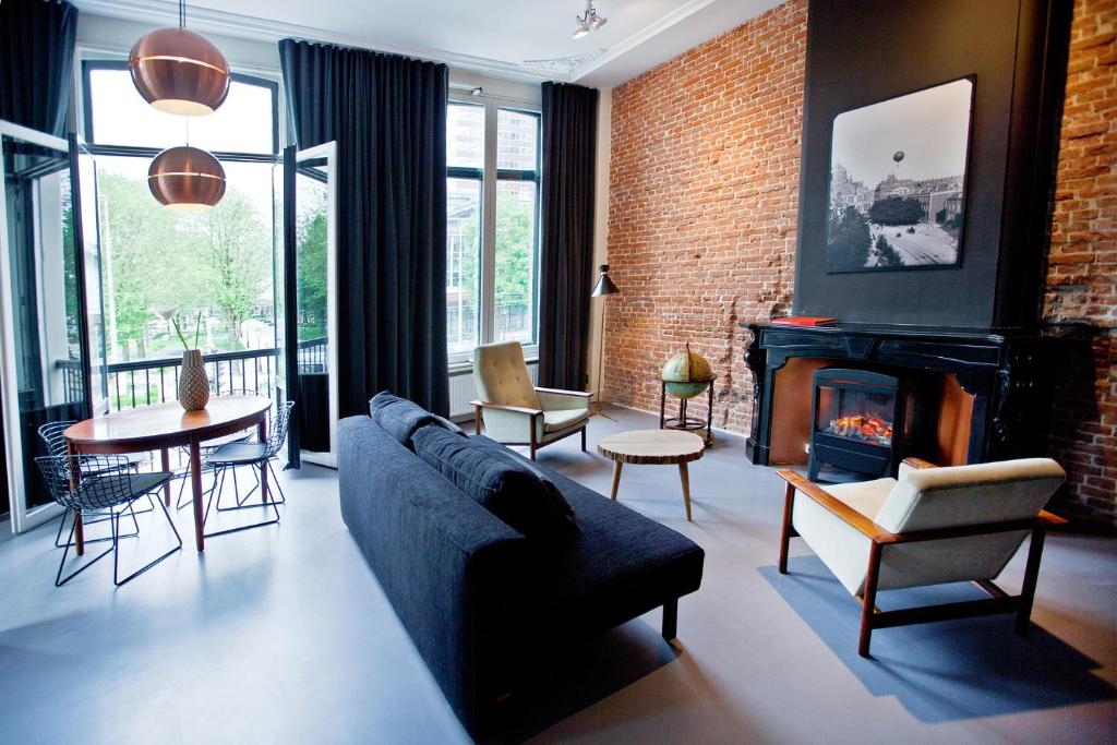 a living room with a couch and a fireplace at V Lofts in Amsterdam