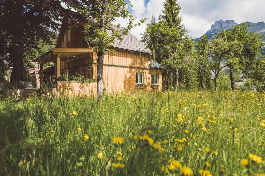 an old house in a field of flowers at Luxus Ferienhaus Altaussee in Puchen