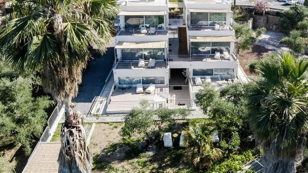 an aerial view of a large white house with palm trees at Laura maisons in Kalamata