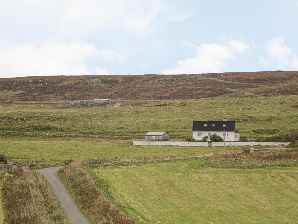 a house in the middle of a field at Hebridean View in Trumpan