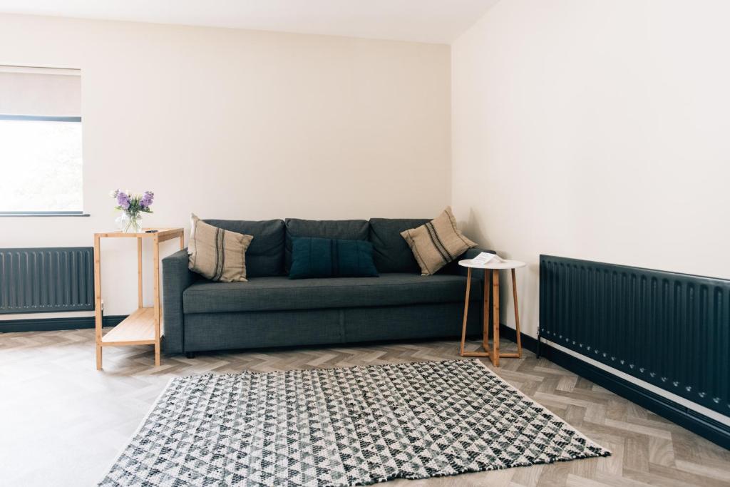 a living room with a couch and a rug at The Fullerton Arms in Ballintoy