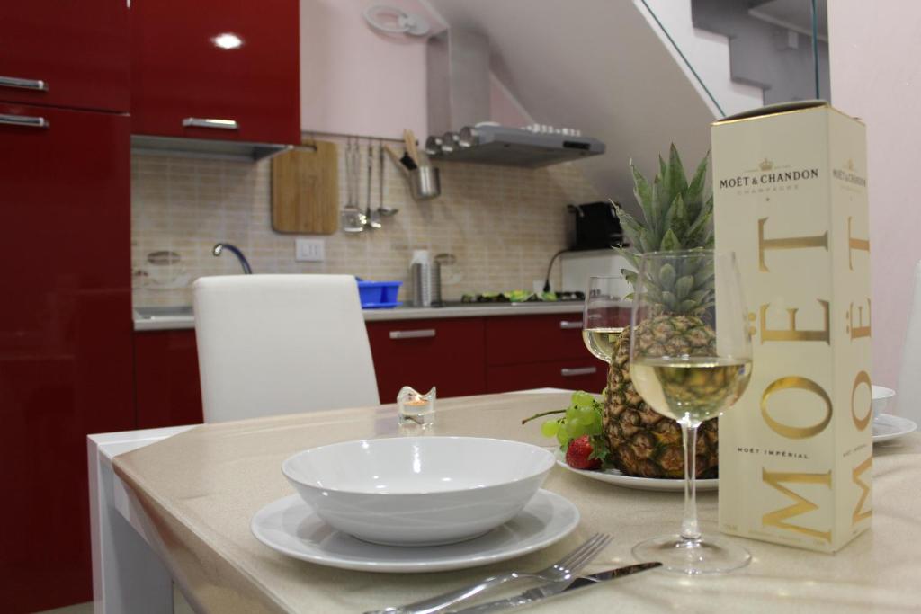 een tafel met een kom en een glas wijn bij mary's house in Catania