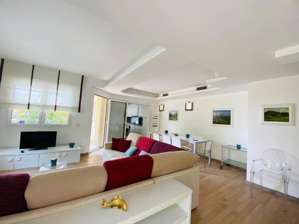 a living room with a couch and a tv at La Villa nel Parco in Sanremo
