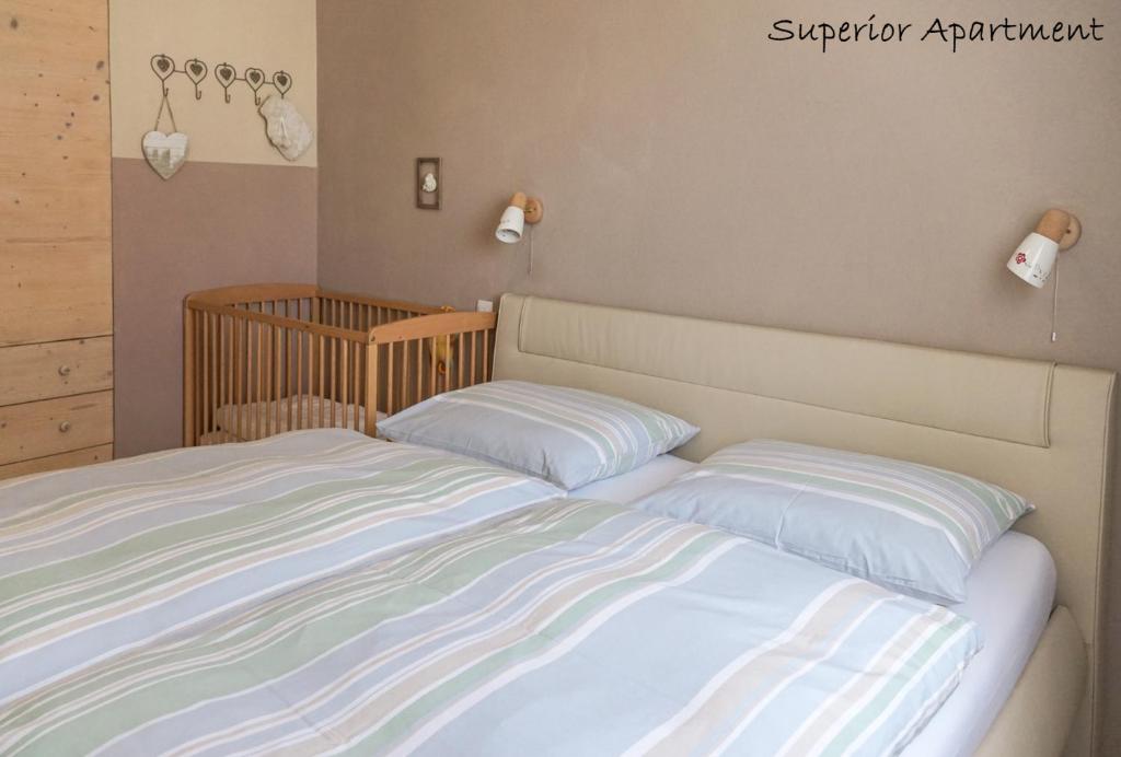 a bedroom with two beds and a crib at Apartment Villa Carolina in Kranjska Gora