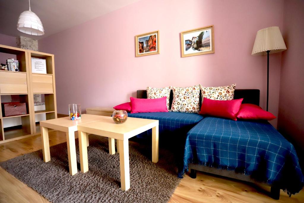 a bedroom with a blue bed and a table at Studio Ulpia in Plovdiv