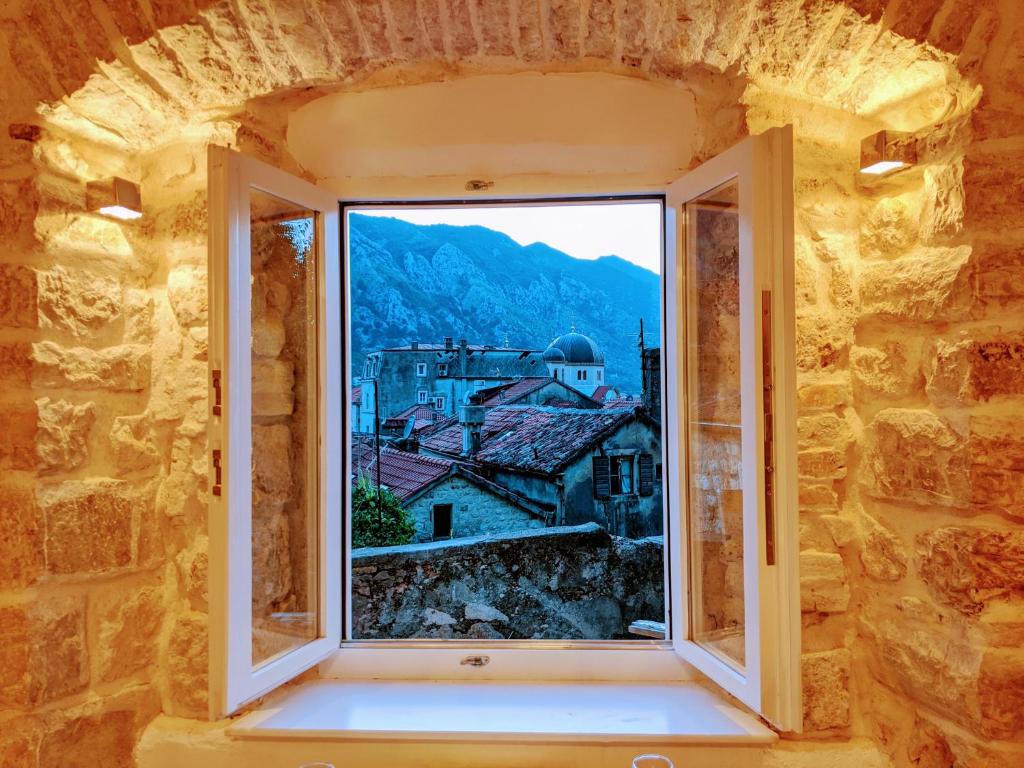an open window with a view of a city at Romantic Rooftop View Hideaway- Old Town Nr 404 in Kotor