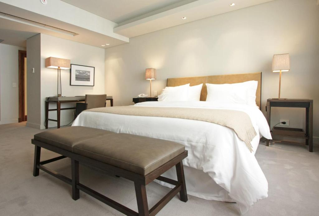 a large bedroom with a large bed with white sheets at Libertad Hotel Buenos Aires in Buenos Aires