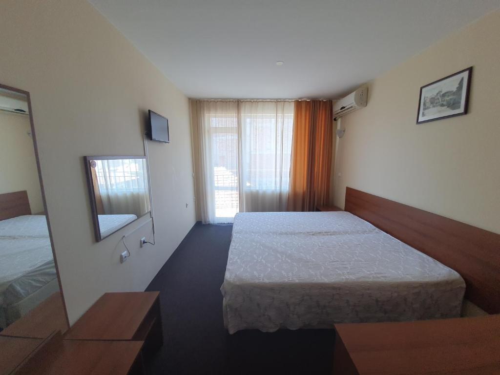 Postel nebo postele na pokoji v ubytování Sandor Hotel