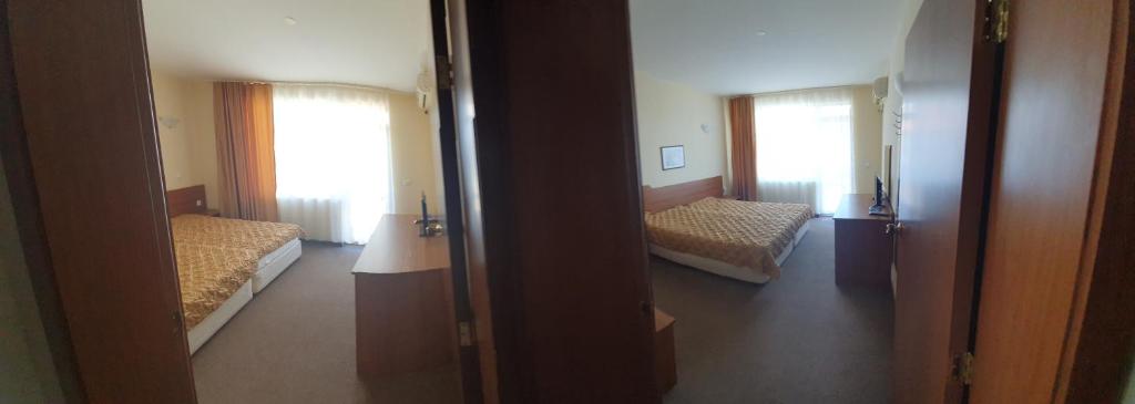 Postel nebo postele na pokoji v ubytování Sandor Hotel