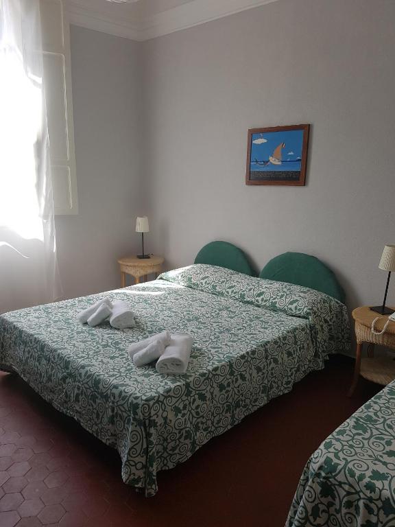 Postel nebo postele na pokoji v ubytování Albergo Lungomare