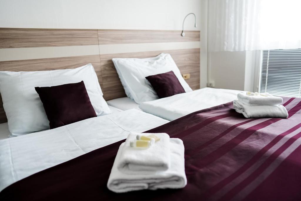 Postel nebo postele na pokoji v ubytování B&B HOTEL UNIVERSITY BRNO