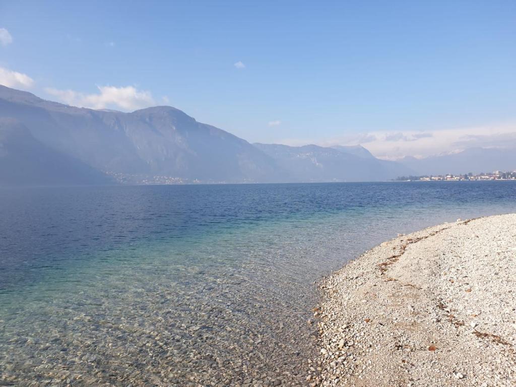 a large body of water with mountains in the background at B&B Le Fate Del Lago in Lierna