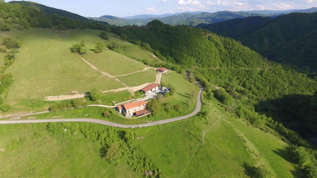 an aerial view of a house on a hill with a road at Agriturismo Cà Nova in Palazzuolo sul Senio