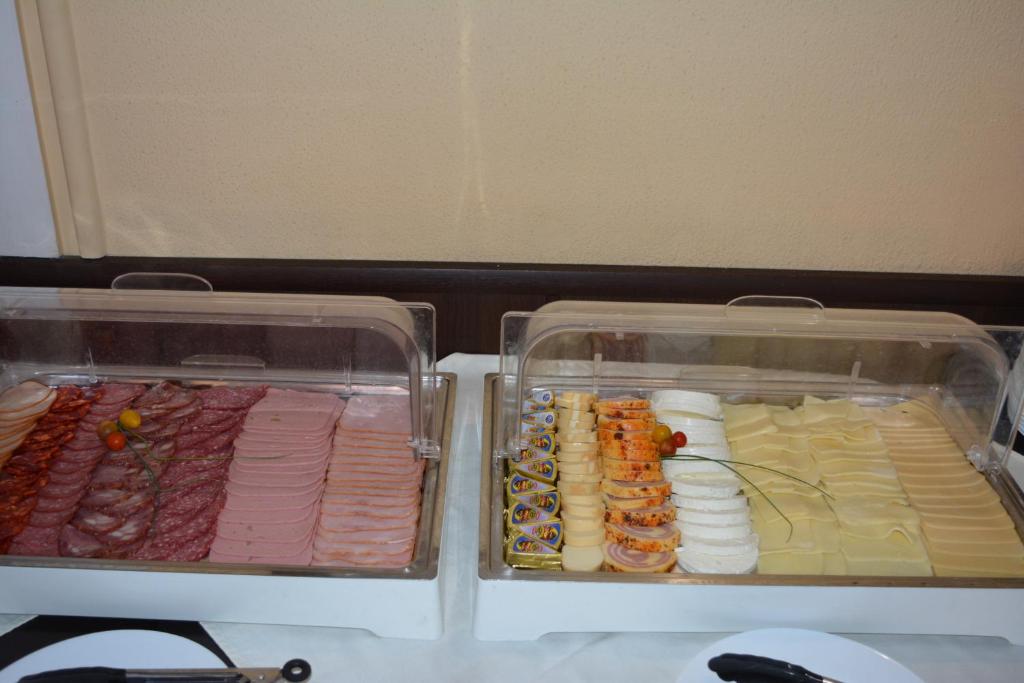two plastic containers of food in a refrigerator at Lotus Family Hotel - Free Parking in Sunny Beach