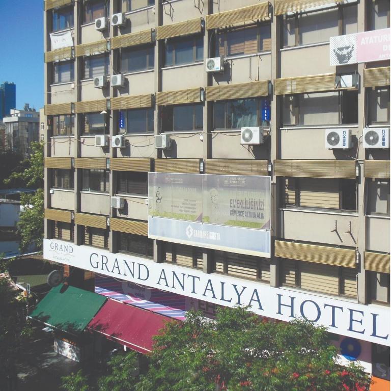 a sign for grand antalya hotel in front of a building at Grand Antalya Hotel in Antalya