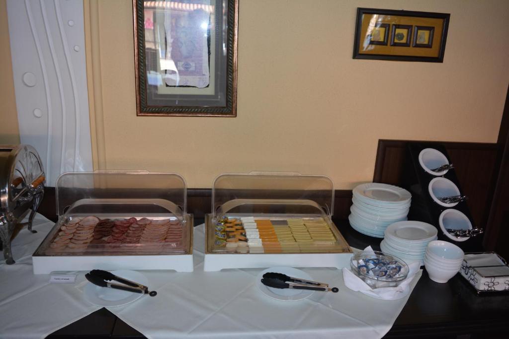 a table with two trays of different types of pastries at Lotus Family Hotel - Free Parking in Sunny Beach