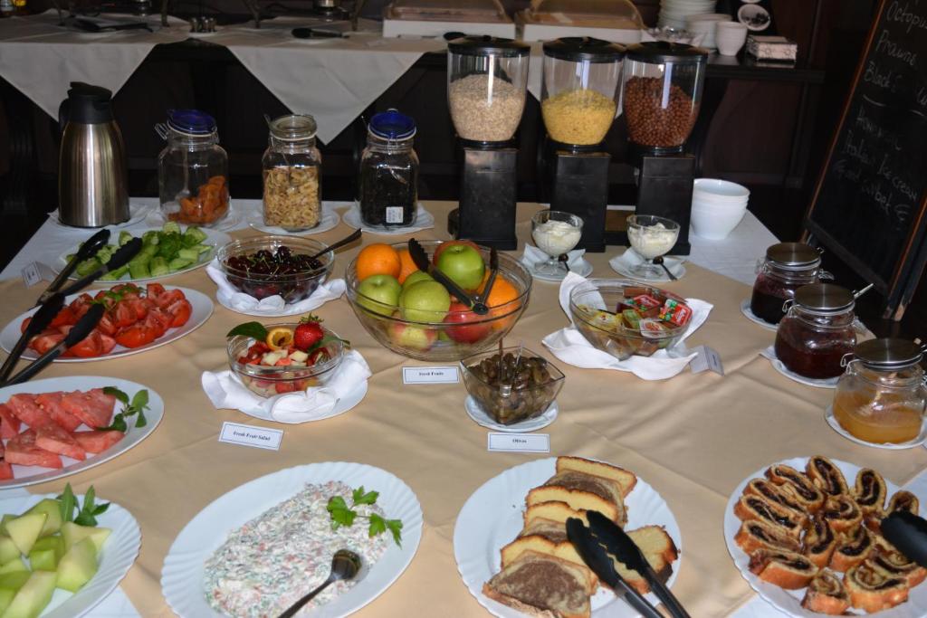 a table with many plates of food on it at Lotus Family Hotel - Free Parking in Sunny Beach