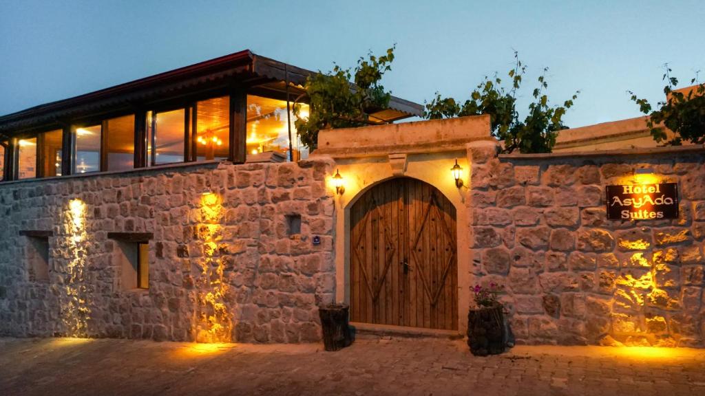 a stone building with a door and a sign on it at Asyada Suites Hotel in Nevsehir