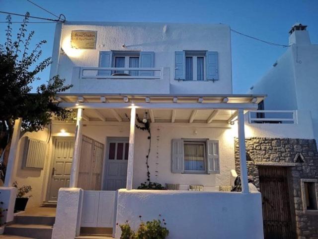 a white house with a fence in front of it at Mina Studios in Platis Yialos Mykonos