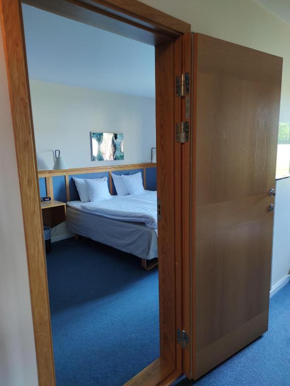 Postel nebo postele na pokoji v ubytování Hotell Erikslund