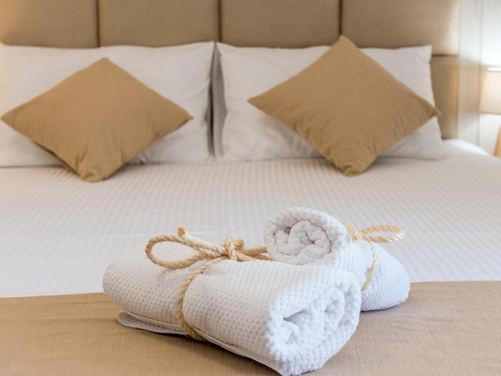 a pair of towels sitting on top of a bed at Square Point Apartments in Kotor