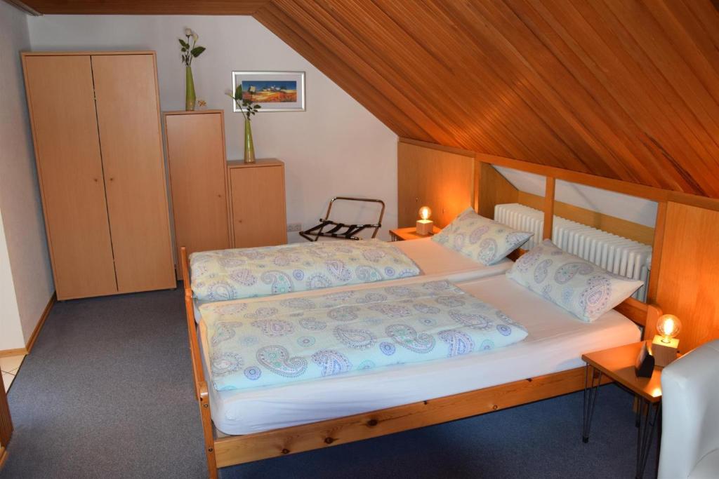 a bedroom with a large bed with a wooden headboard at Pension Wiesner in Hameln