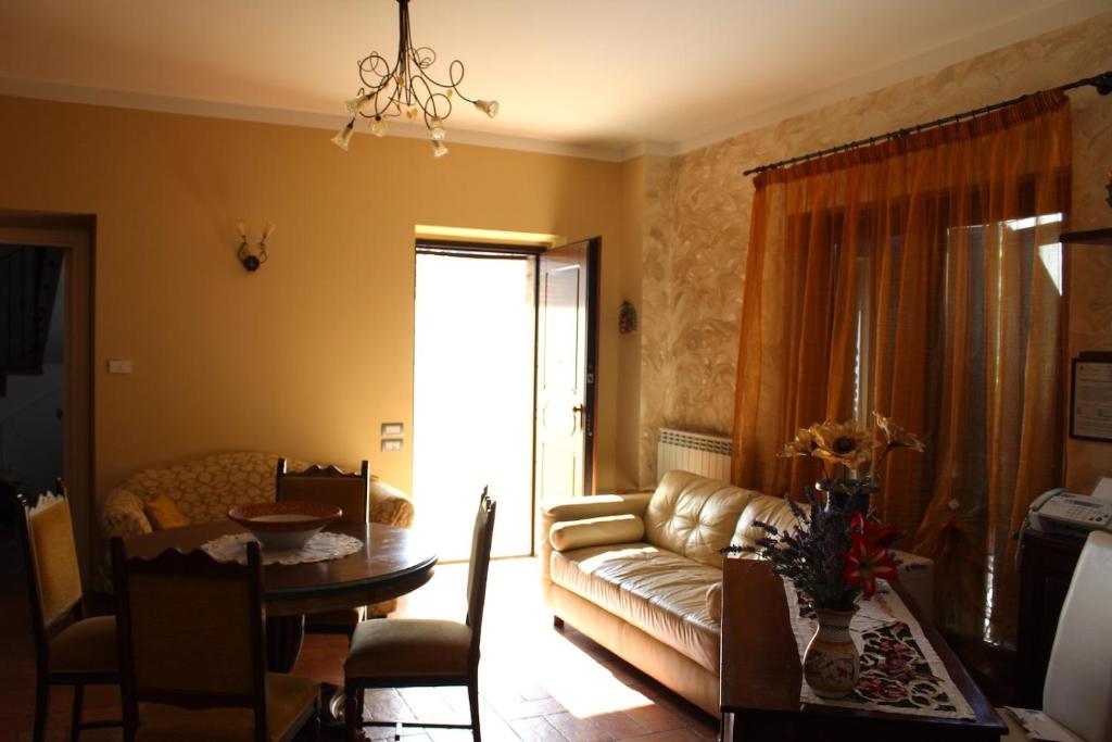 a living room with a couch and a table at La Sorgente Del Sole in San Severino Marche