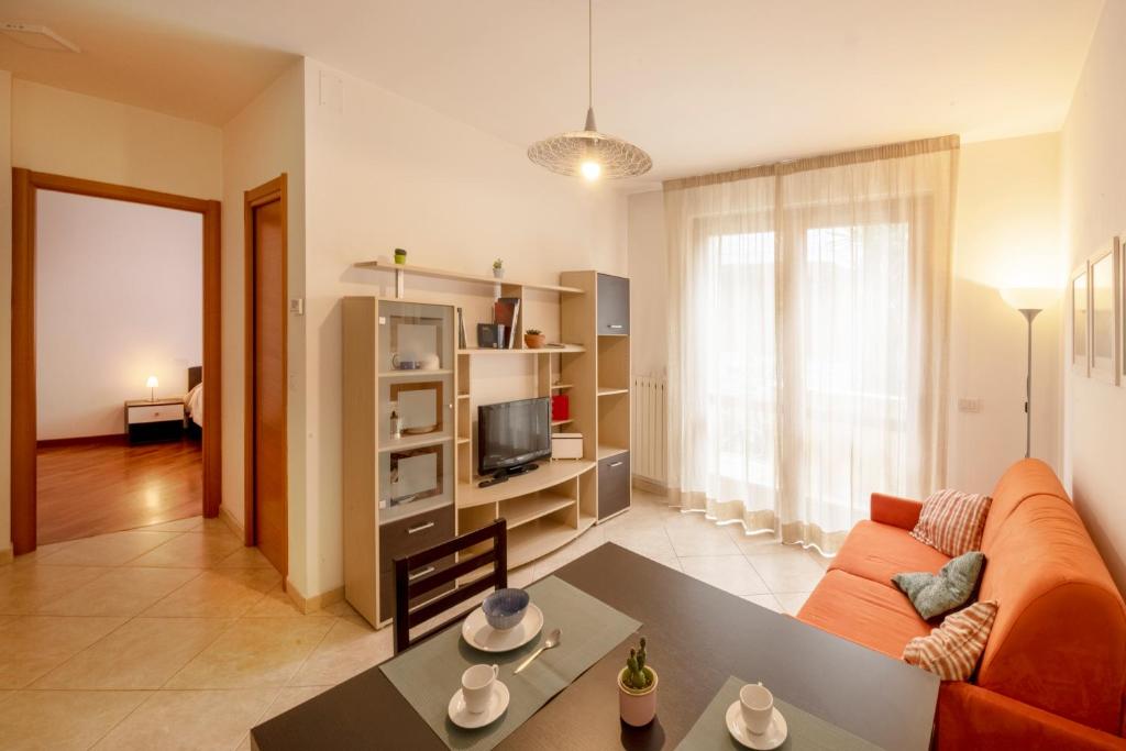 a living room with a couch and a table at Marina Apartment in San Benedetto del Tronto