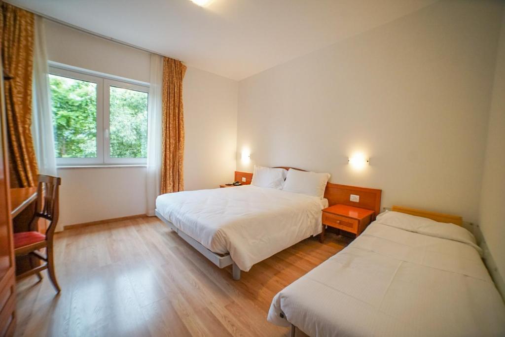 Postel nebo postele na pokoji v ubytování Hotel Nuova Barcaccia