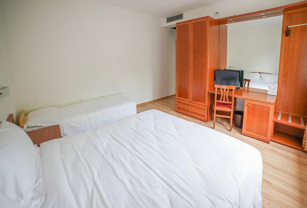 Postel nebo postele na pokoji v ubytování Hotel Nuova Barcaccia