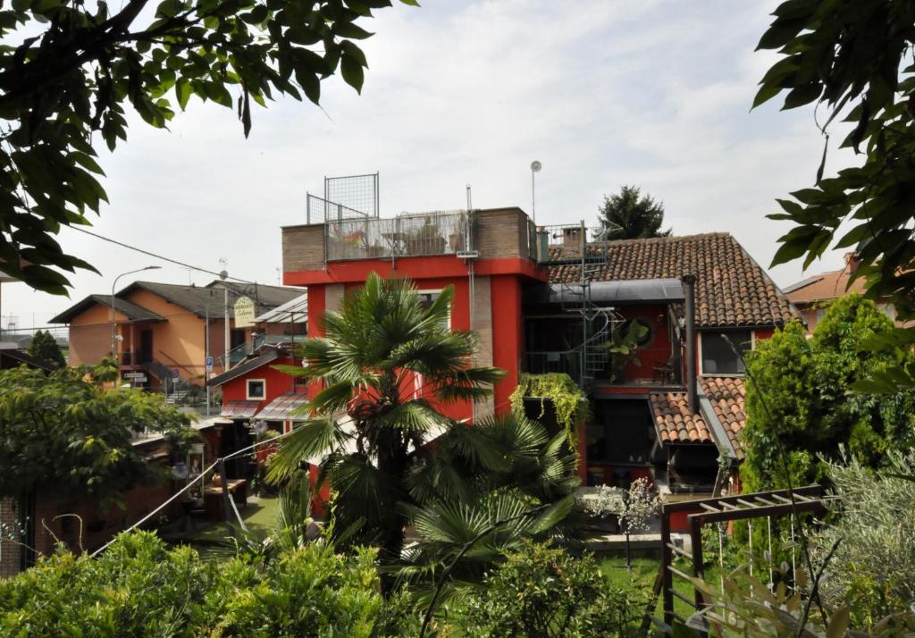 a red building in the middle of a city at B&B Edera in Castagnole Piemonte