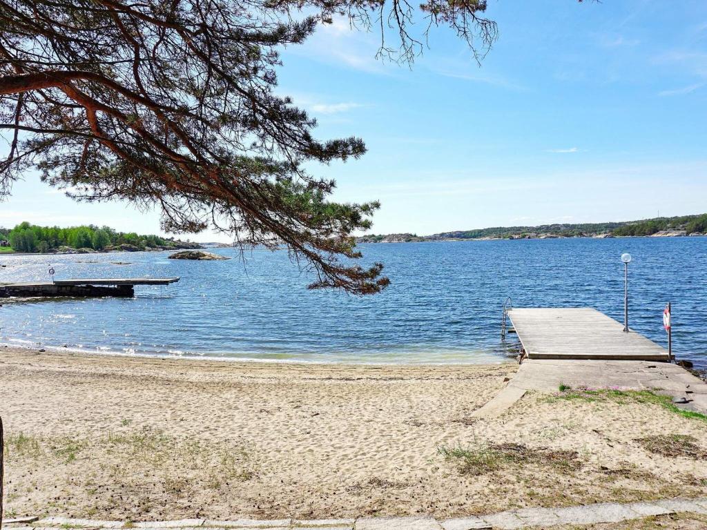 a dock on a beach next to a body of water at 5 person holiday home in STRÖMSTAD in Strömstad