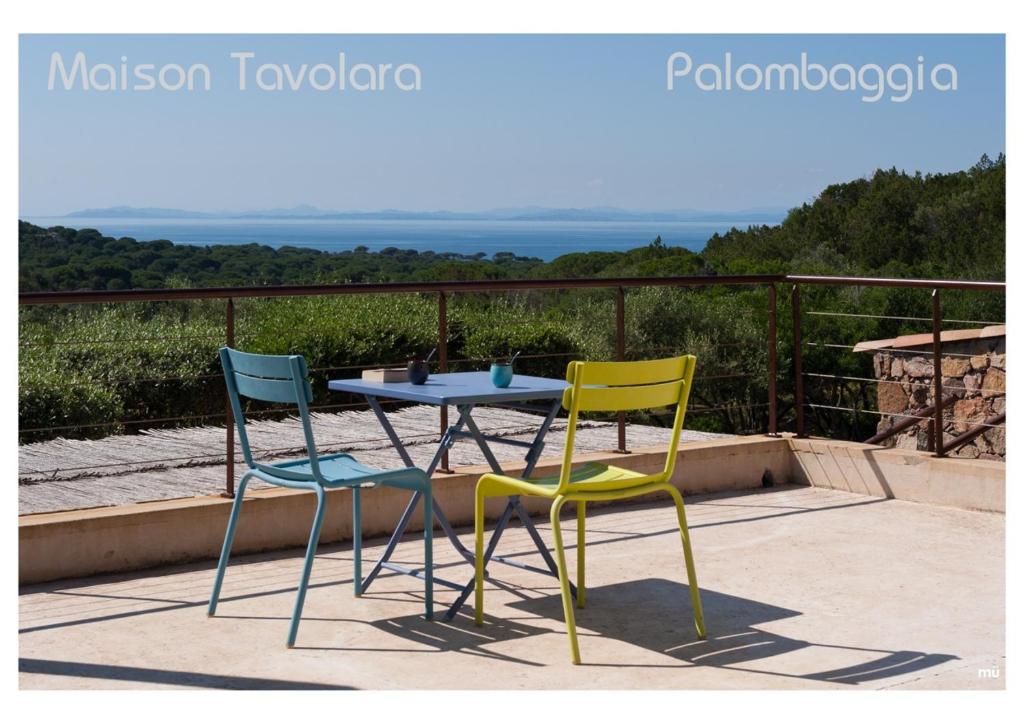 une table et deux chaises assises sur une terrasse dans l'établissement Maison Tavolara, à Porto-Vecchio